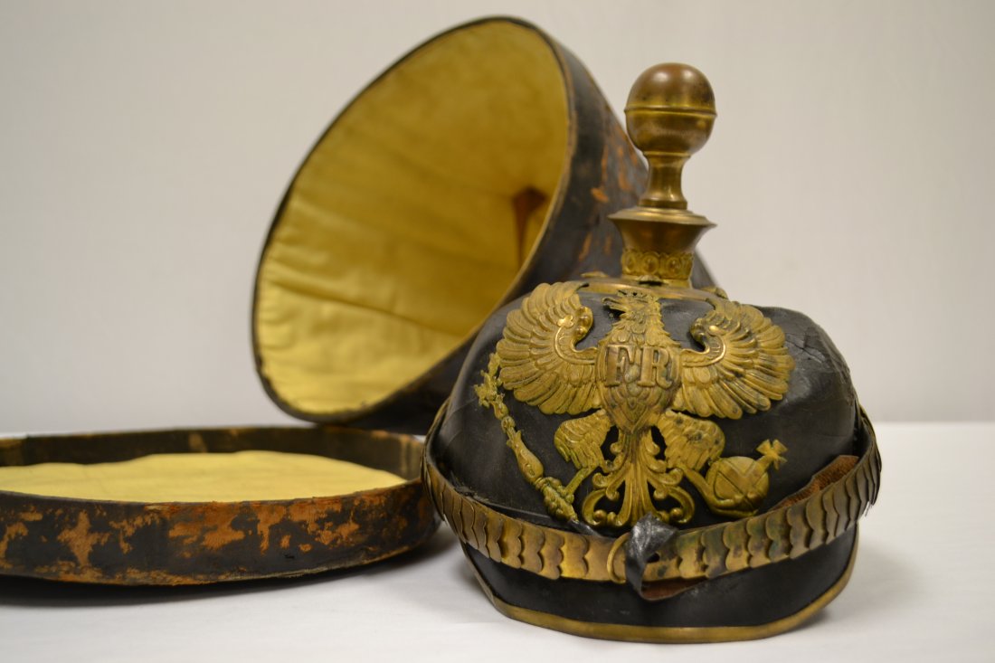 GERMAN PRUSSIAN ARTILLERY OFFICER PICKELHAUBE HELMET: IMPERIAL GERMAN PRUSSIAN ARTILLERY OFFICER PICKELHAUBE HELMET . SHOWS ITS AGE . SOME CRAZING AND DEFORMATION TO A LEATHER BODY. GOLD FINISHED FITTINGS. ORIGINAL LINER IS FULLY INTACT . DISPLAYS GREAT.
