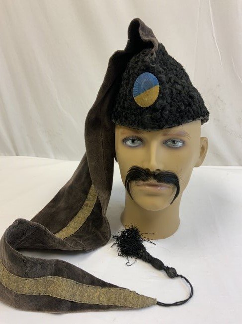 RUSSIAN CIVIL WAR UKRAINIAN NATIONALIST 1919 KOLPAK HAT: RUSSIAN CIVIL WAR UKRAINIAN NATIONALIST 1919 KOLPAK HAT . WORN BY "BLACK STRELSZI" REGIMENT OF UKRAINIAN PEOPLE'S REPUBLIC AROUND 1919 . WELL WORN EXAMPLE LAMB FUR HAT WITH LONG KOLPAK WITH BRASS SCUL