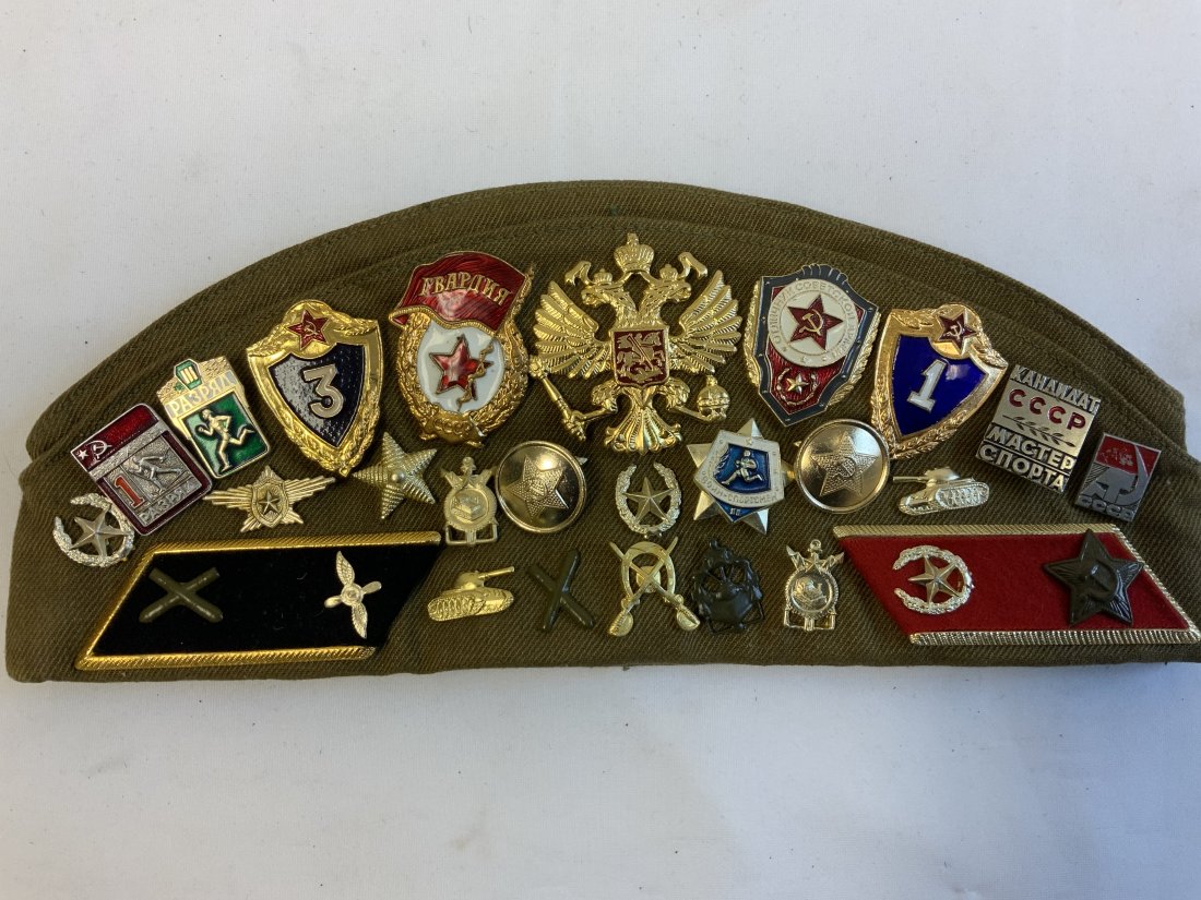 RUSSIA - USSR SOUVENIER CAP WITH PATCHES PINS BADGES: RUSSIA - USSR SOUVENIR CAP WITH PATCHES PINS AND BADGES . SOVIET ERA COLLECTABLE ITEMS ATTACHED TO A USSR SOLDIERS CAP .