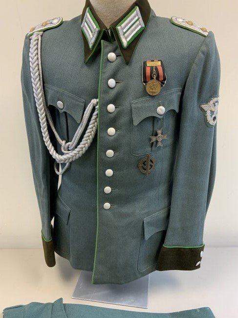 WWII GERMAN POLICE OFFICER DRESS UNIFORM TUNIC PANTS: WWII GERMAN POLICE OFFICER DRESS UNIFORM TUNIC WITH PANTS . VERY NICE SET . HIGH QUALITY TAILORED . COMPLETE WITH AWARDS. TAYLOR LABEL INSIDE AS WELL AS A NAME TAG INSIDE THE POCKET. BEAUTIFUL DISPLAY