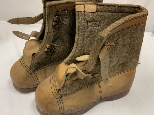 WWII GERMAN COLD WEATHER SENTRY BOOTS EASTERN FRONT: WW2 GERMAN COLD WEATHER SENTRY BOOTS . THICK HEAVY WOOL AND LEATHER BOOTS WITH WOODEN SOLES. KNOWN AS “EAST FRONT BOOTS”, OR “HERMANN MUNSTER BOOTS”. MINTY , UN ISSUED CONDITION. DATED 1943