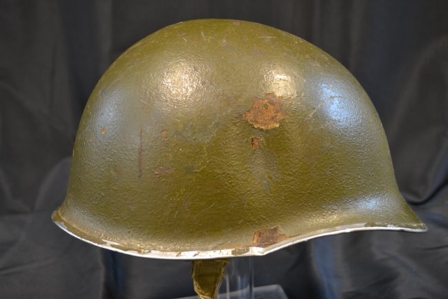 WWII US GI HELMET FIXED BAILES FRONT SEAM: WWII US GI HELMET . FIXED BALES FRONT SEAM . HAS SEEN A LOT OF USE WITH BATTLE SCARS AND DENTS. FRONTAL HIT WITH SOME SORT OF DEBRIS. PARTIAL STRAP REMAINS .