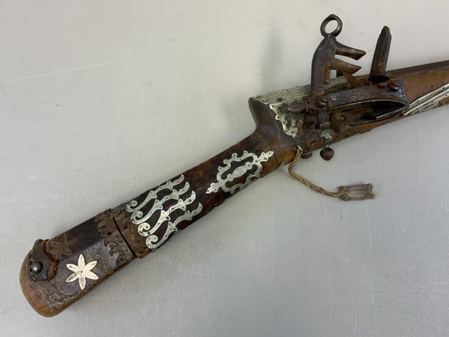 OTTOMAN TURKISH ANTIQUE SHISHANA MIQUELET FLINTLOCK: OTTOMAN Turkish Antique SHISHANA Miquelet Rifle . 18th Century Flintlock Rifle . Shows a great age. Highly decorated with carvings and silver. Very long 52" . Beautiful piece .