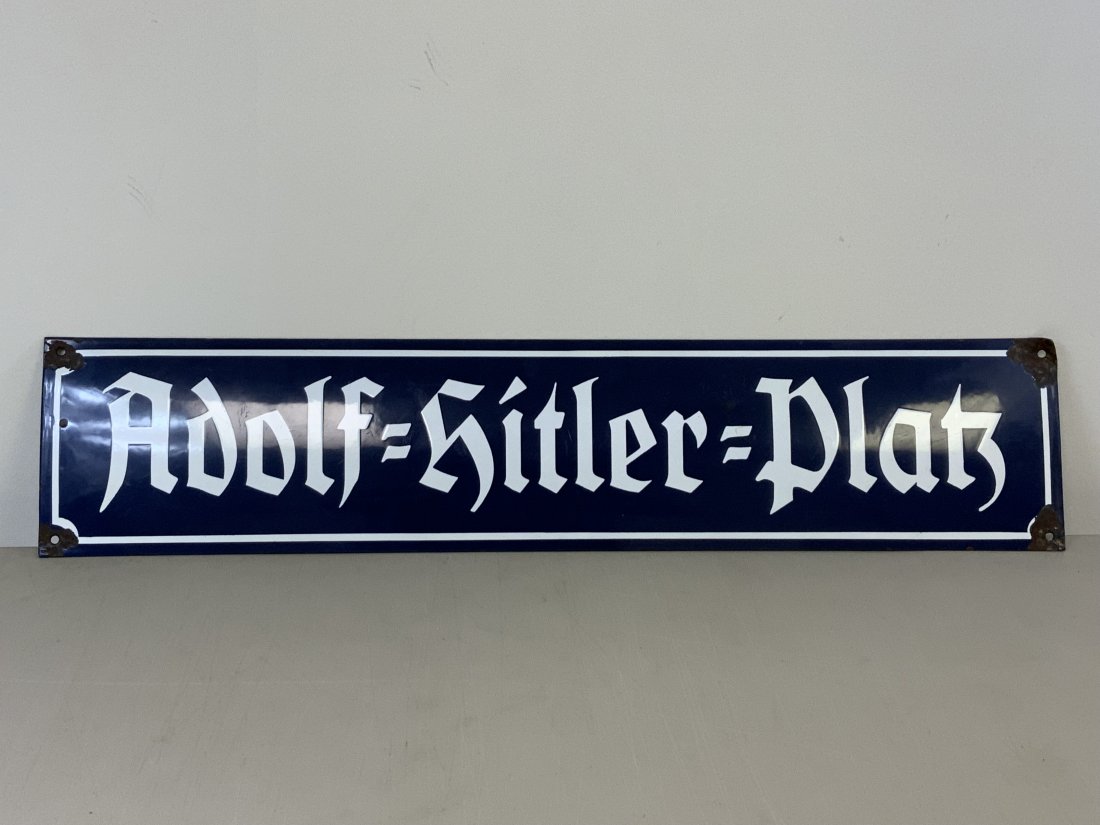 WWII GERMAN ENAMEL STREET SIGN "Adolf Hitler Platz": WWII GERMAN ENAMEL STREET SIGN "Adolf Hitler Platz" NICE BLUE ENAMEL CITY SQUARE SIGN . SOME ENAMEL CHIPPING AND BENDS AROUND MOUNTING HOLES AREAS. SOME RUST SPOTS ON THE REVERSE. THE SIGN IS VAULTED 