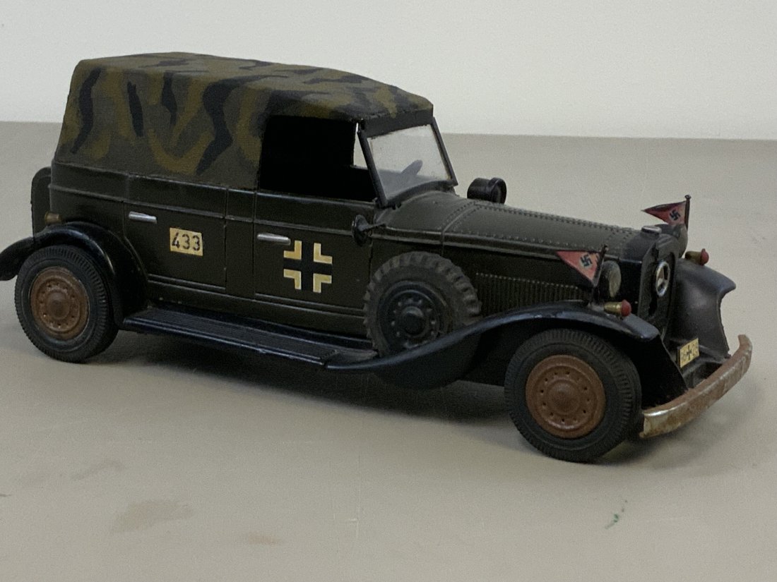 WWII GERMAN MERCEDES STAFF CAR OLD MODEL: WWII GERMAN MERCEDES STAFF CAR OLD MODEL . NICE DETAILS. MARKED "GERMANY" ON THE BOTTOM.METAL BODY . PLASTIC TOP. SOME LARGE SPRING INSIDE FOR THE TIRES BUT WE ARE NOT SURE IF IT WORKS. SOME DAMAGE TO
