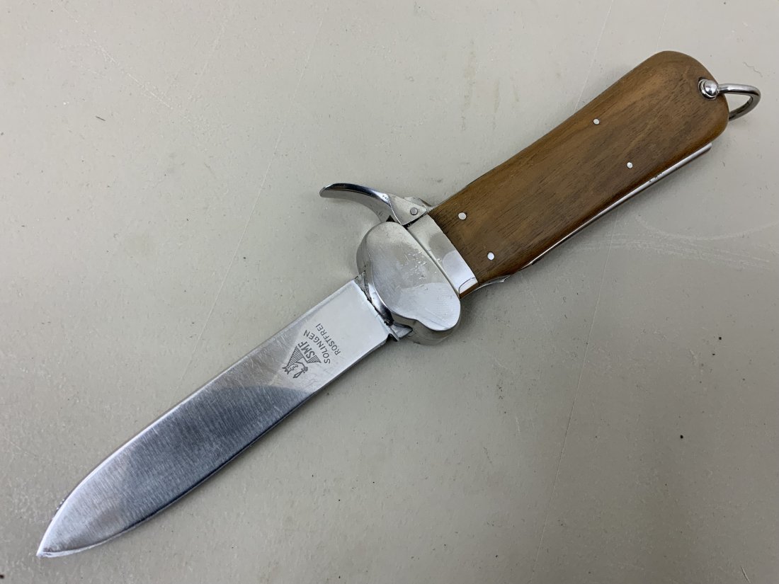 WWII GERMAN PARATROOPER GRAVITY KNIFE SMF SOLINGEN: WWII GERMAN PARATROOPER GRAVITY KNIFE BY SMF SOLINGEN . GREAT CONDITION BLADE AND WOOD COVER GRIP . THE SPRING LEVER IS BROKEN OFF AND REQUIRES REPAIR . NICE CLEAN BLADE . SPIKE FUNCTIONS FINE .