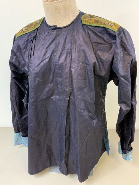 RUSSIAN CIVIL WAR MONGOL BURYAT WHITE ARMY SILK SHIRT: RUSSIAN CIVIL WAR MONGOL BURYAT HORSE BRIGADE ATAMAN SEMENOV WHITE ARMY UNIFORM SILK SHIRT. VERY RARE FIND. COMPLETE WITH SHOULDER BOARDS WITH SWASTIKA TYPE SYMBOLS. BLUE CLOTH LINING. UNIQUE BUTTON C