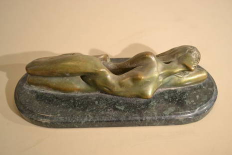 GERART A. BRONZE STATUETTE ON STONE BASE: GERART A. BRONZE STATUETTE ON STONE BASE . LYING FEMALE NUDE. SIGNATURE " GERART A." GREEN STONE BASE . PATINATED BRONZE . 11" X 5"