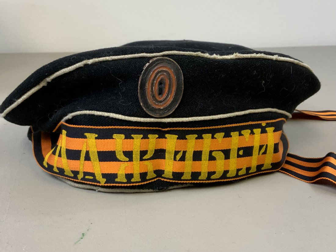 WWI IMPERIAL RUSSIAN DONALD DUCK STYLE SAILOR CAP: WWI IMPERIAL RUSSIAN DONALD DUCK STYLE SAILOR CAP . APPEARS TO BE AN OLD REPRODUCTION POSSIBLE MOVIE OR THEATER USED. WELL WORN CONDITION WITH "HADJIBEI" BATTLESHIP CAP TALLY . SIZE ABOUT 55.