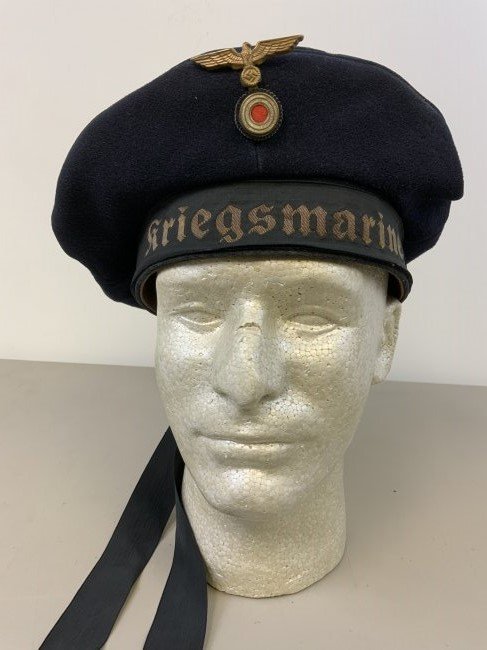 WWII GERMAN KRIEGSMARINE NAVY DONALD DUCK CAP HAT: WWII GERMAN KRIEGSMARINE NAVY SEAMAN'S "DONALD DUCK" CLOTH CAP. BEAUTIFUL CONDITION WITH NORMAL WEAR . COMPLETE WITH "KRIEGSMARINE" CAP TALLY , 2 PIECE INSIGNIA . MAKER LABEL . NAME TAG ALSO SEWED INS