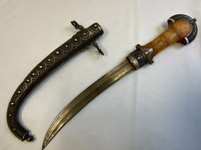 MOROCAN JAMBIYA ISLAMIC DAGGER KOUMMYA: MOROCAN JAMBIYA ISLAMIC DAGGER KOUMMYA . BEAUTIFUL EXAMPLE. HIGHLY DECORATED WITH STRONG FORGED BLADE. YELLOW COMPOSITE GRIP. 12 1/2" LONG WITH 9 1/4" LONG BLADE
