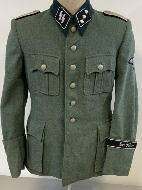 WWII GERMAN SS OFFICER UNIFORM TUNIC " DER FUHRER": WWII GERMAN SS OFFICER UNIFORM TUNIC . BEAUTIFUL QUALITY TAYLOR MADE TUNIC WITH "DER FUHRER" FLAT WIRE TYPE OFFICER CUFF TITLE. VERY NICE AND CLEAN CONDITION. ALL SILVER WIRE BULLION INSIGNIA. NICE AN