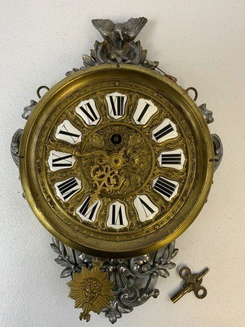 ANTIQUE FRENCH BRASS WALL CLOCK: ANTIQUE FRENCH BRASS WALL CLOCK . BEAUTIFUL PIECE ! ENAMELED NUMERALS . HIGHLY DECORATED . C. 19th CENTURY . COMES WITH A KEY . APPEARS TO BE IN GOOD WORKING CONDITION . RUNS WHEN WINDED BUT CAN NOT C
