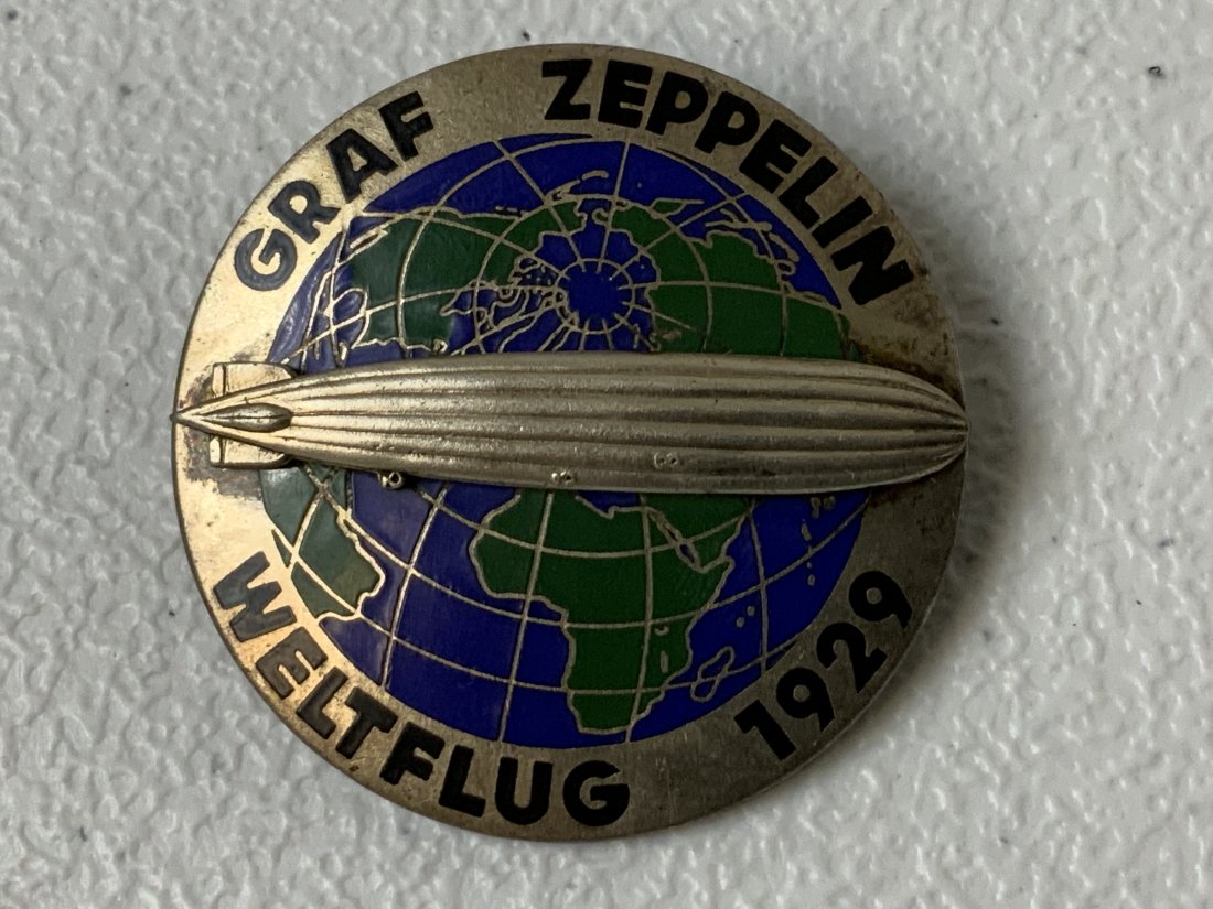ANTIQUE GERMAN GRAF ZEPPELIN WORLD FLIGHT 1929 ENAMEL BADGE: ANTIQUE GERMAN GRAF ZEPPELIN WORLD FLIGHT 1929 ENAMEL BADGE . MAKER MARKED. 1 3/4 DIAM.