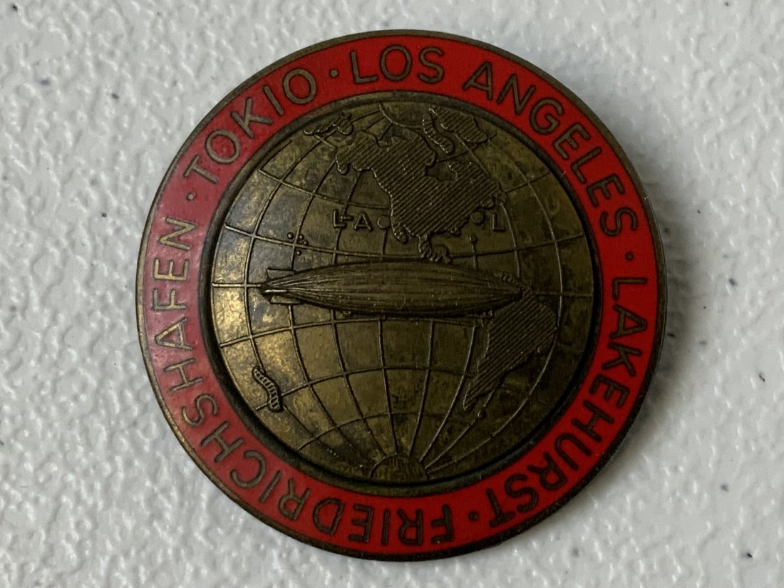 ANTIQUE GERMAN GRAF ZEPPELIN AROUND THE WORLD FLIGHT ENAMEL BADGE: ANTIQUE GERMAN GRAF ZEPPELIN AROUND THE WORLD FLIGHT ENAMEL BADGE . MAKER MARKED. 1 3/4 DIAM.
