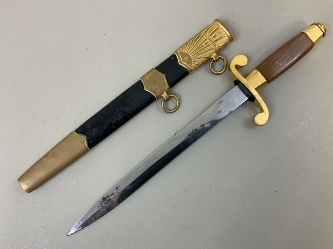 SOVIET RUSSIAN AIRFORCE OFFICERS DRESS DAGGER 1957 DATE: SOVIET RUSSIAN AIRFORCE OFFICERS DRESS DAGGER 1957 DATE . DARK HARDWOOD GRIP . BRASS FITTINGS WITH AIRFORCE INSIGNIA . NUMBER IS GROUND OFF THE BLADE .