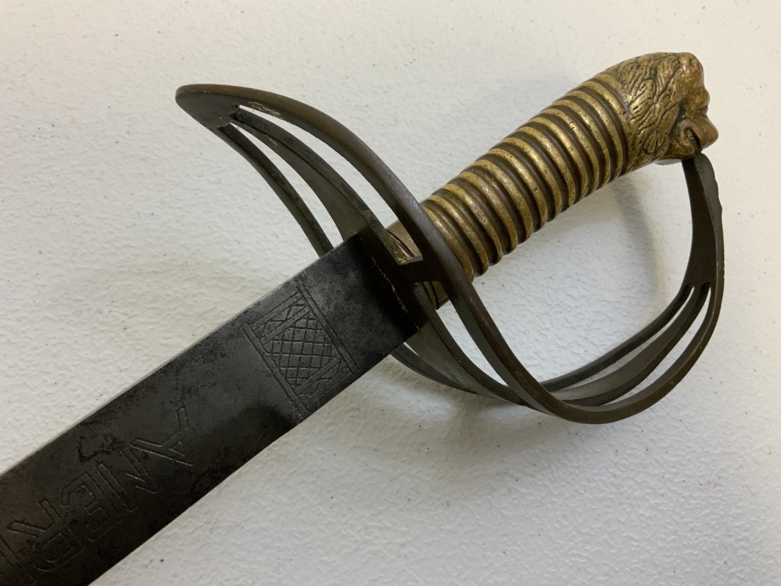 AMERICAN REVOLUTION LIGHT CAVALRY LION HEAD POMMEL SWORD ENGRAVED BLADE: AMERICAN REVOLUTION LIGHT CAVALRY LION HEAD POMMEL SWORD . GREAT CONDITION OVERALL. ENGRAVED BLADE WITH "AMERICAN LIGHT HORSE" AND AMERICAN EAGLE. BRASS GRIP AND CROSS GUARD ASSEMBLY . RARE. 40" LONG 
