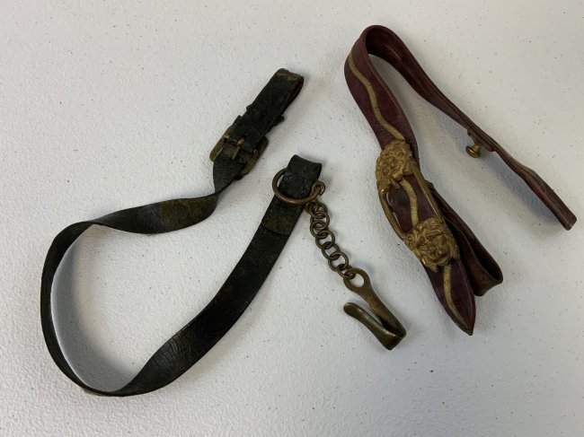 ANTIQUE BRITISH VICTORIAN SWORD SUSPENSION STRAPS: ANTIQUE BRITISH VICTORIAN SWORD SUSPENSION STRAPS . LOT OF 2 . SHOWS A GREAT AGE BUT STILL IN VERY GOOD CONDITION. ONE IS RED LEATHER WITH GOLD WIRE BULLION AND GILDED BRASS LION HEADS BUCKLE . OTHER 