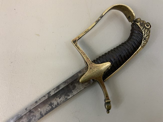 ANTIQUE BRITISH HUSSAR NAPOLEONIC WARS PERIOD SWORD LION HEAD: NAPOLEONIC WARS PERIOD BRITISH HUSSAR SWORD LION HEAD . VERY GOOD CONDITION FOR ITS AGE. BRASS HILT WITH LION HEAD . NICE CURVED BLADE IS STILL SHARP . NO SCABBARD . RARE .38" LONG WITH 32.5 LONG BLAD
