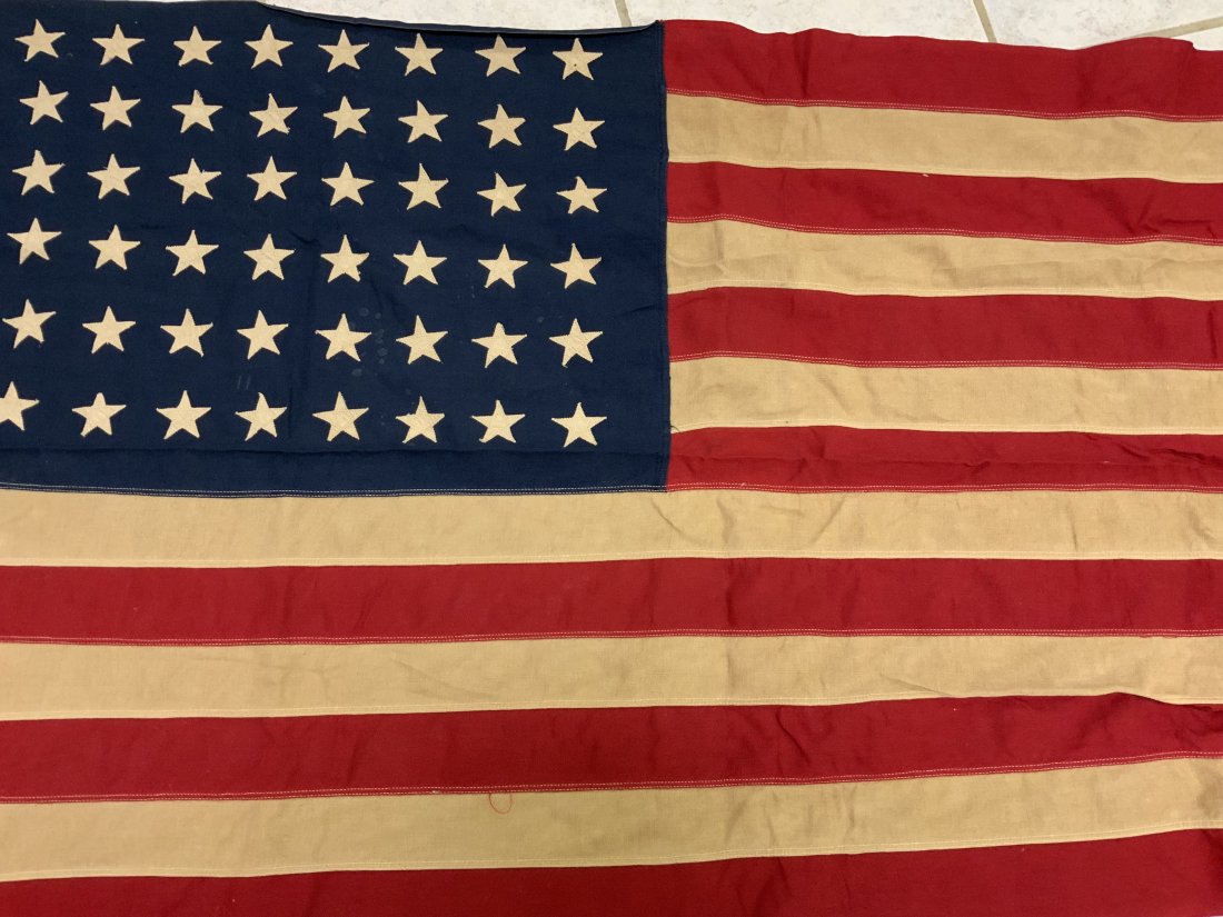 USA VINTAGE WWII ERA 48 STAR AMERICAN FLAG: USA VINTAGE WWII ERA 48 STAR AMERICAN FLAG. MULTI PIECE CONSTRUCTION. NICE SMALLER SIZE FOR DISPLAY 55 X 32 . SHOWS AGE AND WEAR . MANUFACTURING LABEL STILL ATTACHED.