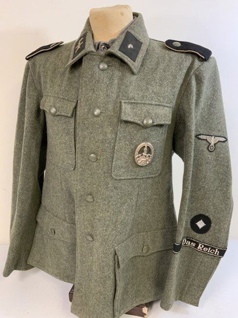 WWII GERMAN WAFFEN SS M42 UNIFORM TUNIC MOVIE USED " SAVING PRIVATE RYAN" 1998: WWII GERMAN WAFFEN SS "DAS REICH" M42 UNIFORM TUNIC . CONSIGNOR STATES IT WAS MOVIE USED " SAVING PRIVATE RYAN" 1998 STEVEN SPIELBERG PARAMOUNT PICTURES. VERY GOOD SLIGHTLY USED CONDITION. PAPER TAG W