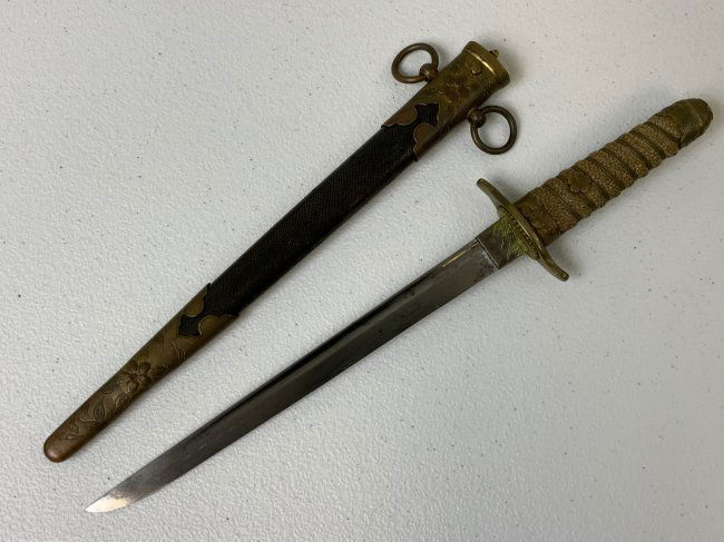 WWII JAPANESE IMPERIAL NAVY OFFICER DAGGER WITH SCABBARD: WWII JAPANESE IMPERIAL NAVY OFFICER DAGGER WITH SCABBARD . VERY NICE CONDITION . SHARK SKIN WRAPPED SCABBARD. NICE BRASS FITTINGS. NICE BLADE WITH ONE GROOVE WITH NO FLAWS JUST SOME DARK SPOTS AND SHO