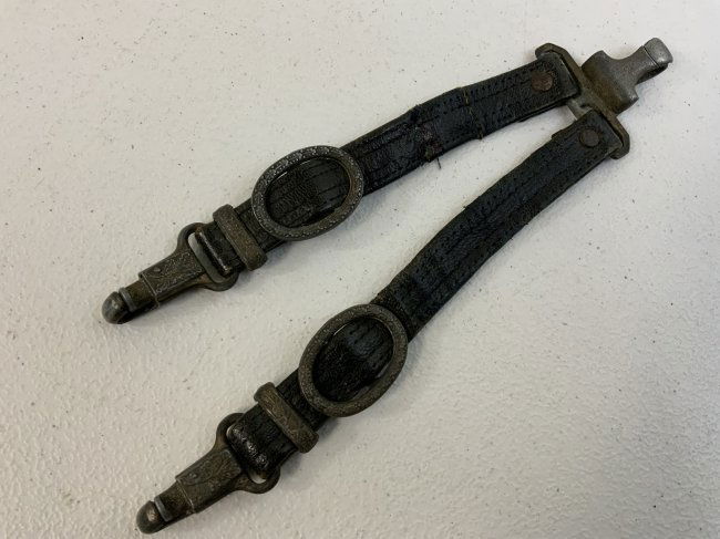 WWII GERMAN RLB OFFICERS DAGGER HANGERS: WWII GERMAN RLB OFFICERS DAGGER HANGERS . VERY RARE TO FIND. THIS SET IS WELL WORN BUT STILL IN GOOD CONDITION . ONE REPAIR ON THE BACK . D.R.G.M.MARKED SNAPS AND RZM MARKED CLIP. .