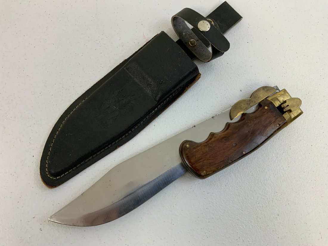 LARGE FOLDING HUNTING KNIFE WITH SHEET: LARGE FOLDING HUNTING KNIFE WITH SHEET. GOOD CONDITION . 17" LONG WITH 11" LONG BLADE WHEN UNFOLDED.