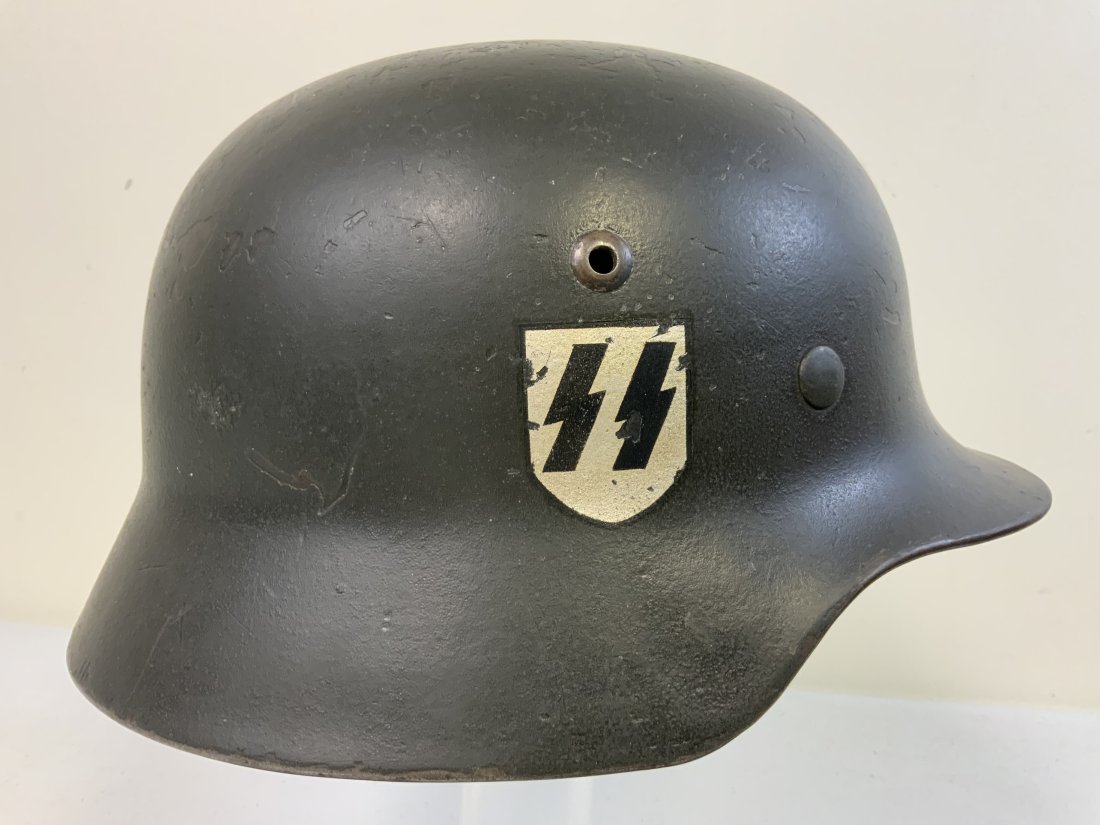 WWII GERMAN WAFFEN SS M35 HELMET NAMED TO LAH SS MAN WITH HISTORY: WWII GERMAN WAFFEN SS M35 HELMET NAMED TO LAH SS MAN. THIS M35 HELMET STARTED A S A DOUBLE DECAL ARMY HELMET MADE BY DEUTSCHE NICKELWERKE IN SCHWERTE. IT IS STAMPED NS62 ON THE RIM INSIDE. IN THE SUMM