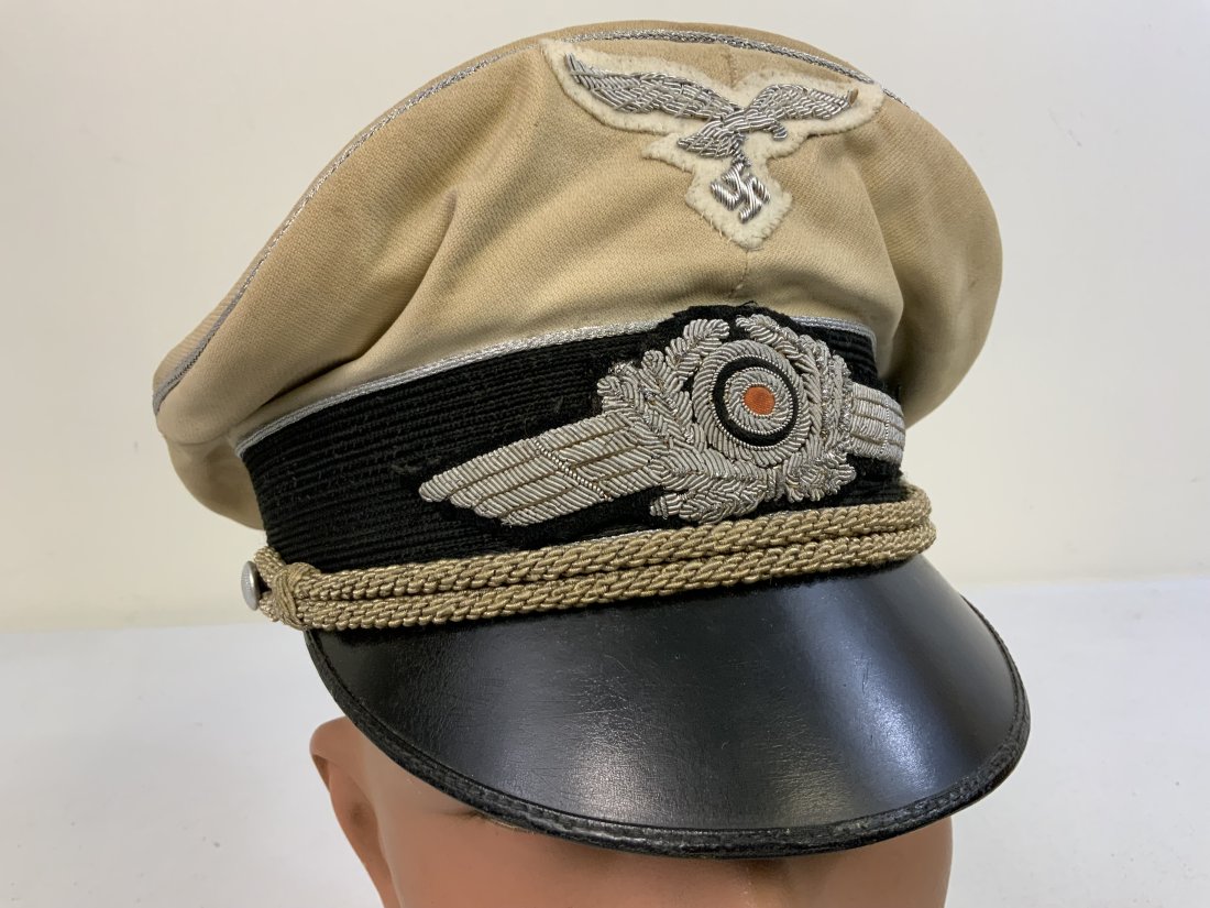 WWII GERMAN LUFTWAFFE OFFICER WHITE TOP VISOR HAT CAP: WWII GERMAN LUFTWAFFE OFFICER WHITE TOP VISOR HAT CAP . WELL WORN CONDITION WITH SOME STAINS TO THE WHITE TOP. NON REMOVABLE TOP. THE CAP EAGLE APPEARS TO BE A POSTWAR REPLACEMENT. VERY NICE LOOKING C