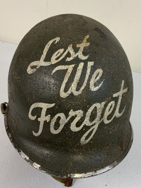 WWII US M1 STEEL HELMET WITH GI LOGO PAINTED: WWII US M1 STEEL HELMET WITH GI LOGO PAINTED. SHOWS ITS AGE WITH SOME DENTS AND CORROSION. SOME WELDED REPAIRS TO A STEEL BODY. STAINLESS STEEL RIM WITH FRONT SEAM. SWIVEL BALE. WEB CHIN STRAP. GI LOG