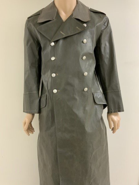 WWII GERMAN MILITARY MOTORCYCLE RIDER LONG RUBBERIZED COAT: WWII GERMAN MILITARY MOTORCYCLE RIDER LONG RUBBERIZED COAT . GREAT CONDITION FOR ITS AGE. GRAY MATERIAL FINISHED COLLAR. COMPLETE WITH ALL BUTTONS AND SHOULDER STRAPS. INK MARKED INSIDE . RARE TO FIND