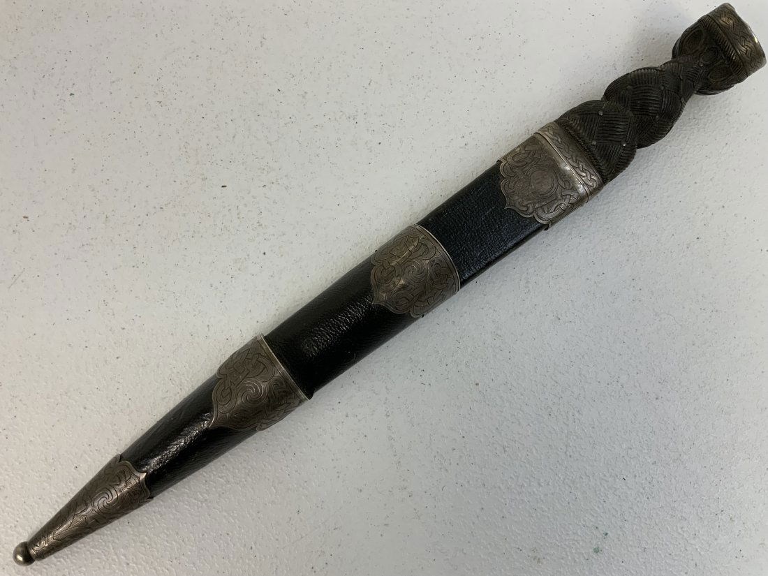 ANTIQUE SCOTTISH DIRK DAGGER: ANTIQUE SCOTTISH DIRK. SILVER FITTINGS ENGRAVED WITH SCOTTISH TRADITIONAL MOTIFS. NAMED ON THE BACK . GREAT BLADE. SHOWS GREAT AGE. NICE EXAMPLE. 16 1/2" LONG WITH 11" LONG BLADE.