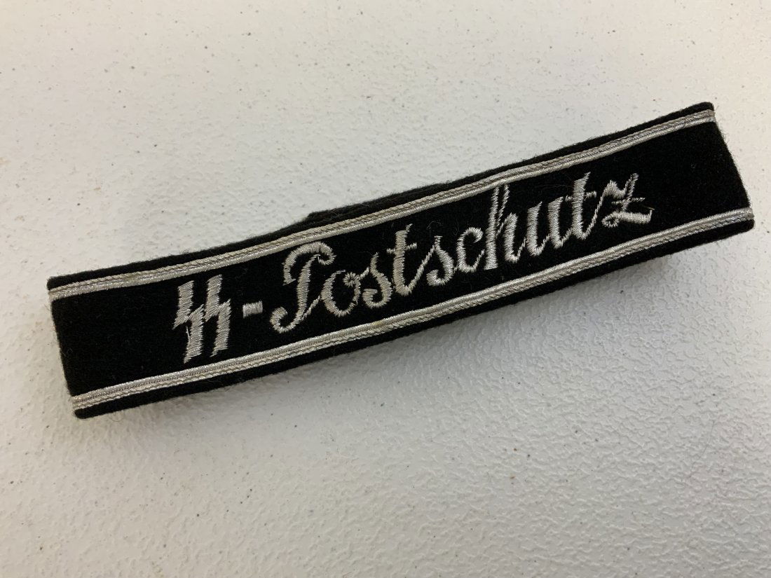GERMANY THIRD REICH SS-POSTSCHUTZ CUFF TITLE: GERMANY THIRD REICH SS-POSTSCHUTZ CUFF TITLE . RARELY SEEN RARE CUFF TITLE. SILVER WIRE EMBROIDERED. GREAT CONDITION. 16" TOTAL LENGTH .