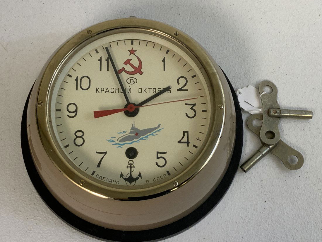 USSR NAVY SHIPS SUBMARINE WALL CLOCK: USSR NAVY SHIPS SUBMARINE WALL CLOCK . HEAVY METAL BODY . COMES WITH 2 KEYS. FULLY WORKING CONDITION. COMPLETE WITH WALL MOUNTING PLATE. 8" DIAMETER.