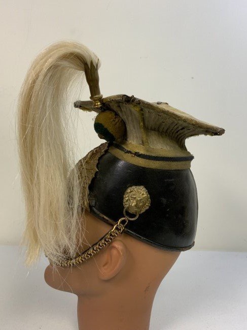 ANTIQUE BRITISH 17th LANCERS CAP HELMET WITH WHITE HORSEHAIR PLUMAGE: ANTIQUE BRITISH 17th LANCERS CAP HELMET WITH WHITE HORSEHAIR PLUMAGE. CIRCA 1900. WELL USED BUT COMPLETE. BODY IN GOOD SHAPE WITH ORIGINAL BRASS FRONT PLATE ATTACHED. WHITE WOOL ON THE LANCET TOP HAS 