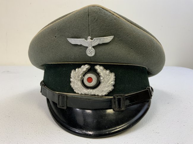 WWII GERMAN NCO OFFICERS INFANTRY VISOR CAP HAT: WWII GERMAN NCO OFFICERS INFANTRY VISOR CAP HAT . WELL WORN BUT STILL IN GOOD CONDITION WITH SOME MOTH NIPS BUT NOTHING BAD. MAKER MARKED UNDER SWEAT SHIELD. SIZE ABOUT 57.