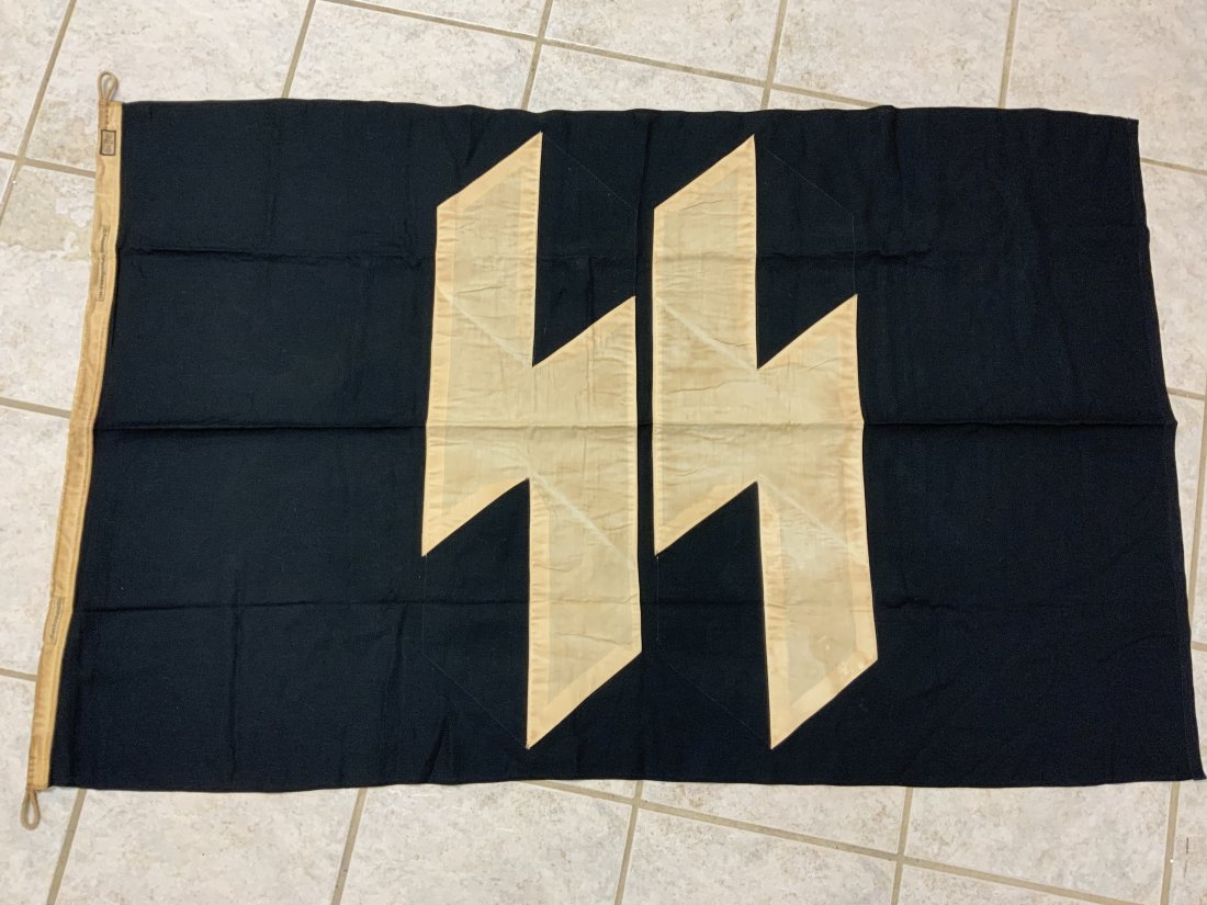 WWII GERMANY THIRD REICH BLACK SS FLAG BANNER: WWII GERMANY THIRD REICH BLACK SS FLAG BANNER. MULTY PIECE CONSTRUCTION WITH SEPARATELY APPLIED SS RUNES. DOUBLE SIDED. 53 X 34 SIZE . MAKERS LABELS AND RZM TAG.