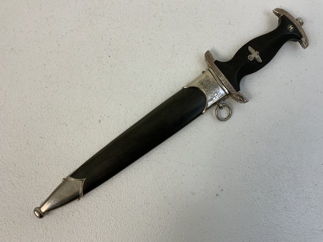 THIRD REICH GERMANY M33 SS DAGGER EICKHORN HIMMLER INSCRIBED: THIRD REICH GERMANY M33 SS DAGGER . GREAT LOOKING EARLY QUALITY DAGGER. VERY UNIQUE PIECE. VERY INTERESTING ENGRAVED CROSS GUARDS AND CARVED EBONY WOOD GRIP. VERY UNIQUE AND INTERESTING DAGGER . EICKH