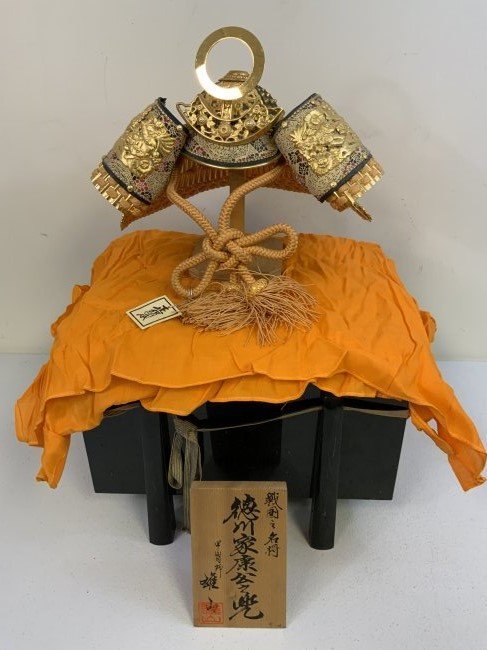 JAPAN VINTAGE JAPANESE SAMURAI DISPLAY DOLL KABUTO HELMET WITH TRUNK: JAPAN VINTAGE JAPANESE SAMURAI DISPLAY DOLL SIZE MINIATURE KABUTO HELMET WITH TRUNK . BEAUTIFUL WORKMANSHIP . HIGHLY DECORATED . 24 KARAT GOLD PLATED DECORATIVE FITTINGS. ABOUT HALF THE SIZE OF ORIGIN