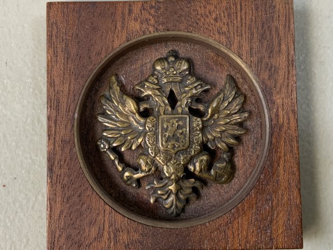 IMPERIAL RUSSIA BRASS HAT EAGLE MOUNTED IN WOODEN FRAME: IMPERIAL RUSSIA BRASS EAGLE MOUNTED IN WOODEN FRAME. PERIOD IMPERIAL RUSSIAN CAP EAGLE. WOOD FRAME 2 X 2 WITH HANGING LOOP.