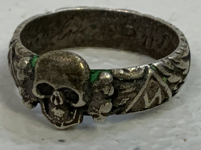 WWII GERMAN SILVER SS SCULL RING DEAT'S HEAD SS: WWII GERMAN SILVER SS SCULL RING DEAT'S HEAD SS TOTENKOPFRING . SILVER WITH PATINA. GREAT DETAILS .LIKELY POSTWAR PRODUCED. 800 STAMPED NAMED AND HIMMLER'S SIGNATURE INSIDE. SIZE 10