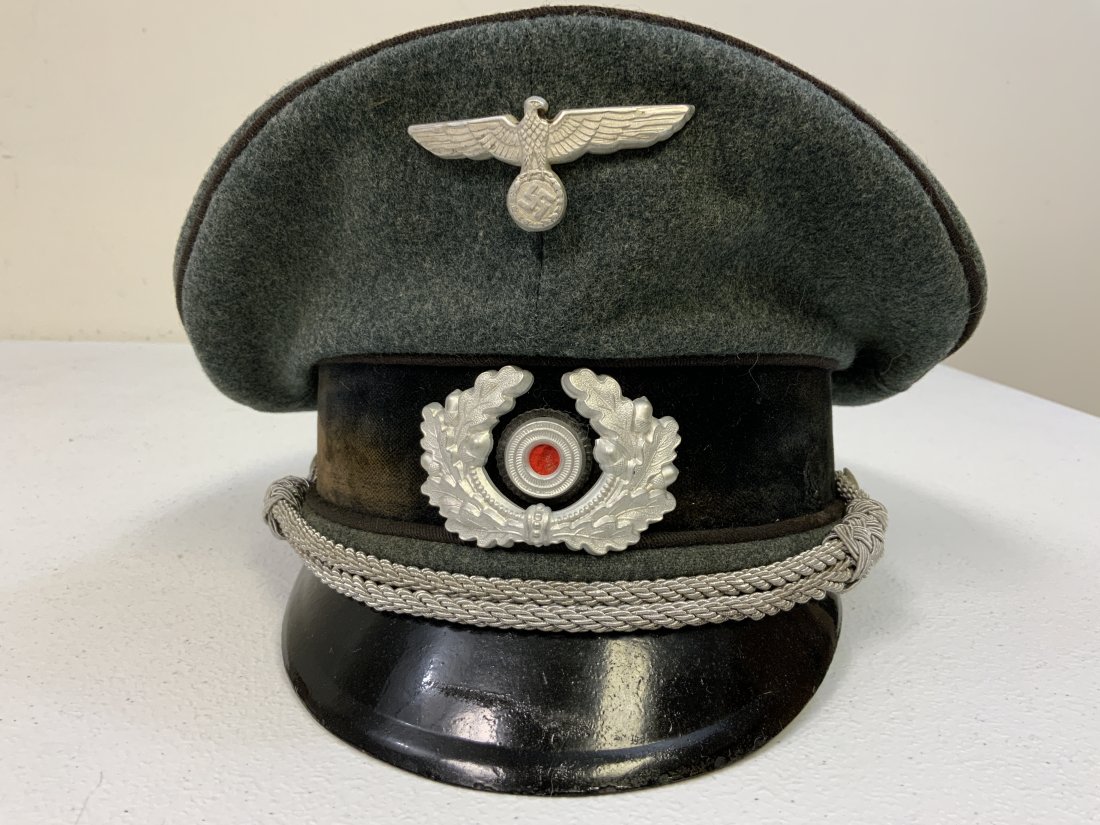 WWII GERMAN ARMY PIONEER OFFICERS VISOR HAT CAP: WWII GERMAN ARMY PIONEER OFFICERS VISOR HAT CAP . VERY INTERESTING CAP. LOOKS TO BE EX SS PIONEER CAP . HAS AN SS PIONEER OFFICER NAME INSIDE . BLACK PIPED WITH BLACK VELVET BAND. OVERALL GOOD WORN CO