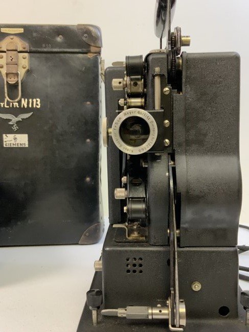 WWII GERMANY SIEMENS 16 MM FILM MOVIE PROJECTOR LUFTWAFFE USED BERLIN MARKED: WWII GERMANY SIEMENS 16 MM FILM MOVIE PROJECTOR LUFTWAFFE USED BERLIN MARKED. RARE FIND ! ORIGINAL LEATHER CASE. LUFTWAFFE EAGLE AFFIXED TO THE BOX AND PROJECTOR BODY . MANY MARKINGS. SOME MARKS IN WH