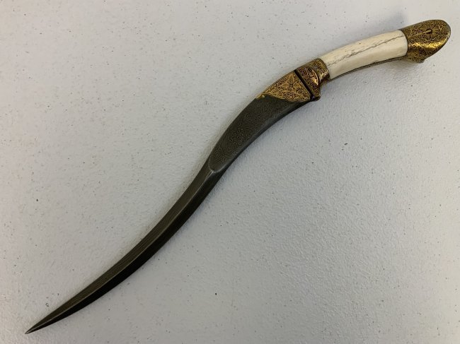 INDO PERSIAN DAMASCUS STEEL BLADE GOLD DECORATED DAGGER: INDO PERSIAN DAMASCUS STEEL BLADE GOLD DECORATED DAGGER . VERY BEAUTIFUL AND HIGHLY DECORATED PIECE . BONE GRIP. 16" LONG WITH 11" BLADE.