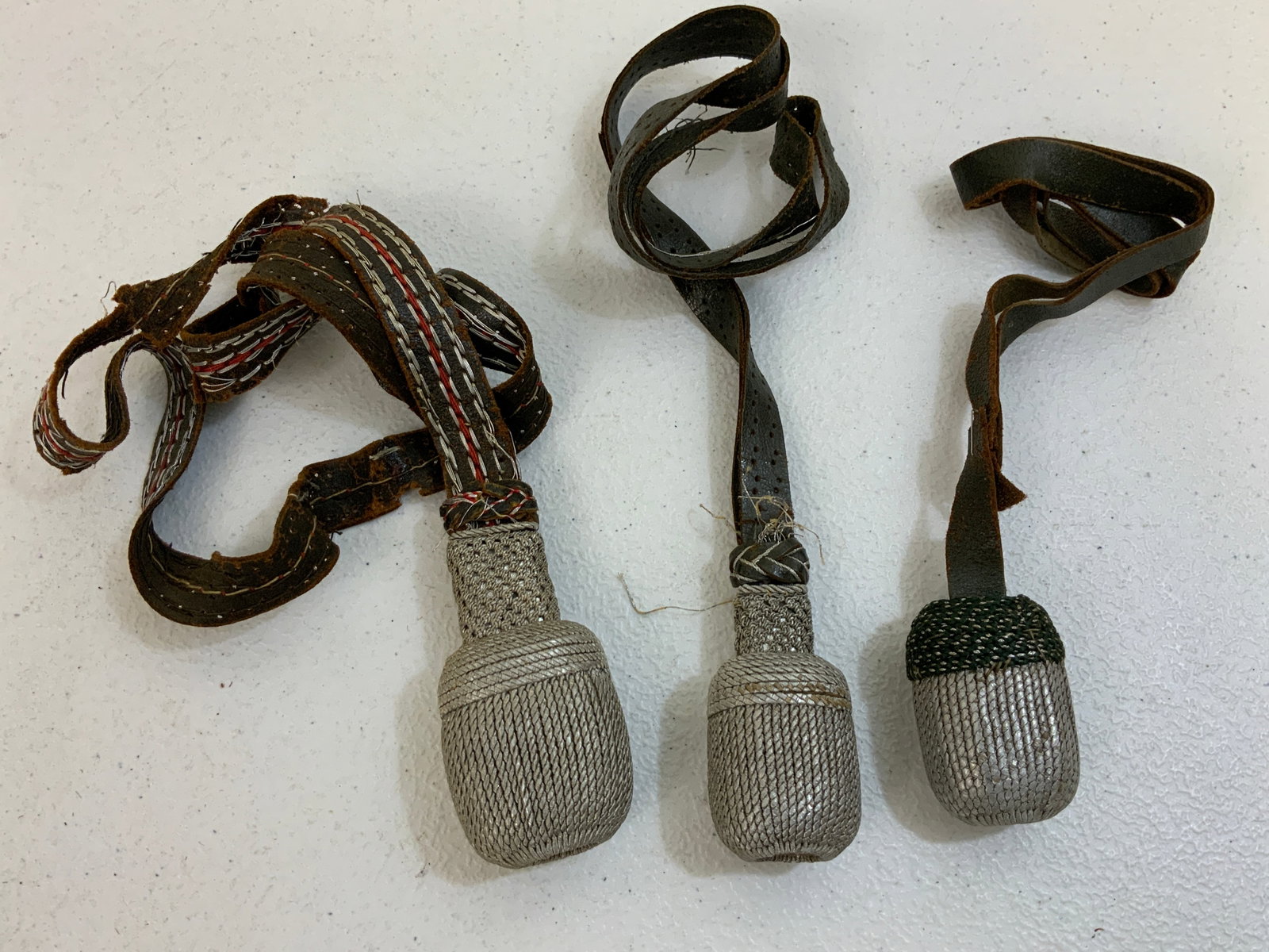 WWII GERMAN BAYONET AND SWORD KNOTS: WWII GERMAN BAYONET AND SWORD KNOTS . ALL WELL WORN WITH SOME TEARS.