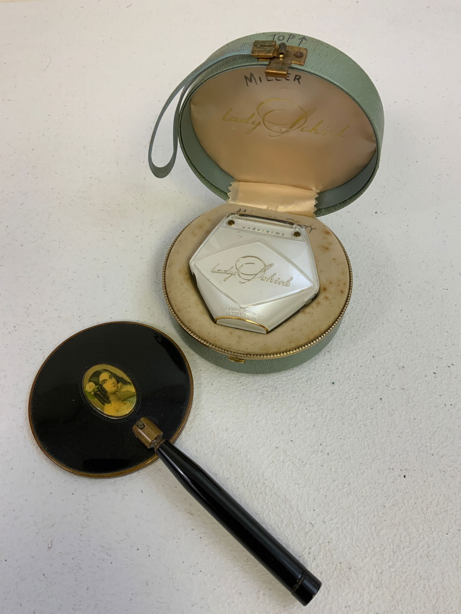 VINTAGE FEMALE ACCESSORIES: VINTAGE FEMALE ACCESSORIES . ELECTRICAL SHAVER AND HAND HELD MIRROR. CIRCA 1950'S.