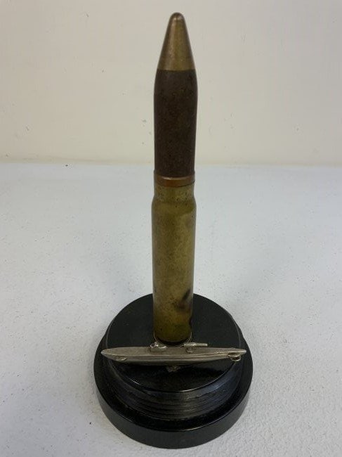 WWII GERMAN NAVY SUBMARINE U-BOAT TRENCH ART LIGHTER: WWII GERMAN NAVY SUBMARINE U-BOAT TRENCH ART LIGHTER . NICELY MADE FROM BAKELITE CAP APPROX. 4 1/8" DIAM. WITH LARGE CALIBER GUN ROUND WITH TOP MADE INTO LIGHTER AND SILVER COLOR METAL U- BOAT MODEL .