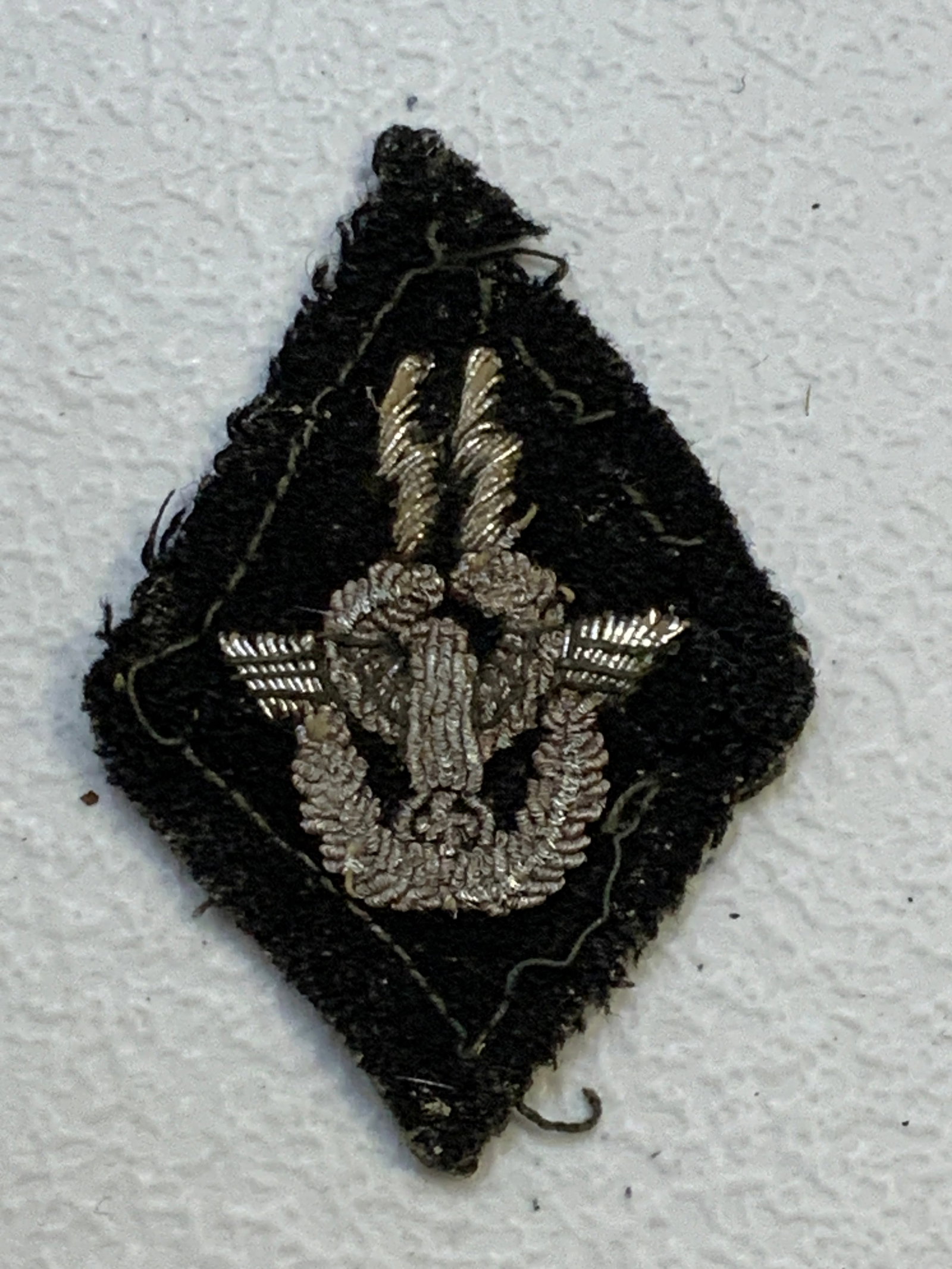 WWII GERMAN SS POLICE OFFICERS SLEEVE DIAMOND TUNIC REMOVED: WWII GERMAN SS POLICE OFFICERS SLEEVE DIAMOND TUNIC REMOVED. VERY RARE INSIGNIA. WELL WORN CONDITION. TUNIC REMOVED IN SILVER ALUMINUM WIRE EMBROIDERY.