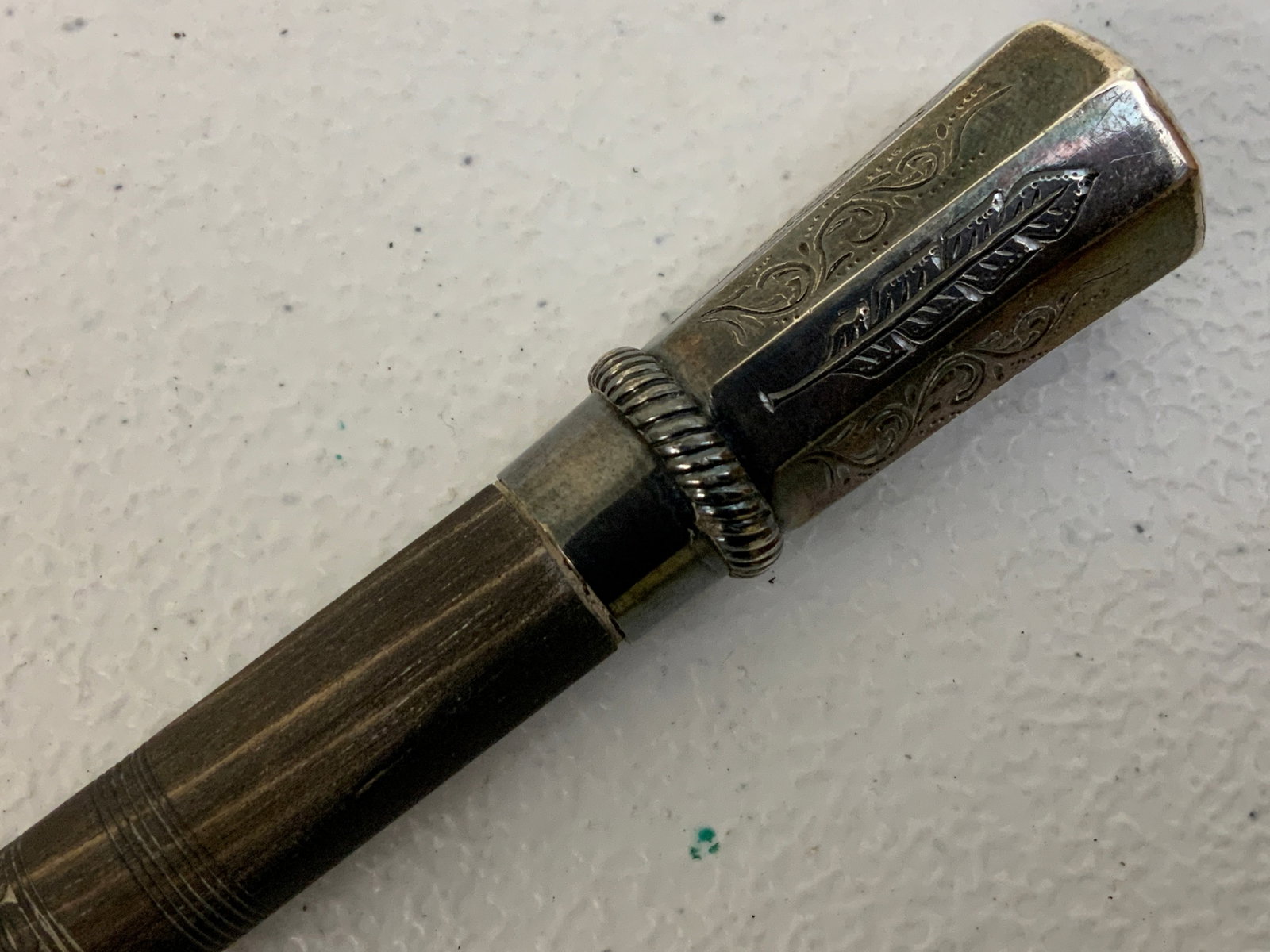 ANTIQUE BRITISH SCOTTISH NOBLEMAN EBONY CARVED WOOD SILVER MOUNTED SWAGGER STICK: ANTIQUE BRITISH SCOTTISH NOBLEMAN EBONY CARVED WOOD SILVER MOUNTED SWAGGER STICK . 22 1/2" LONG. DECORATED SILVER TOP MOUNT WITH MONOGRAM TO THE TOP . SILVER TIP. CRACK TO THE CARVED EBONY WOOD SHAFT 